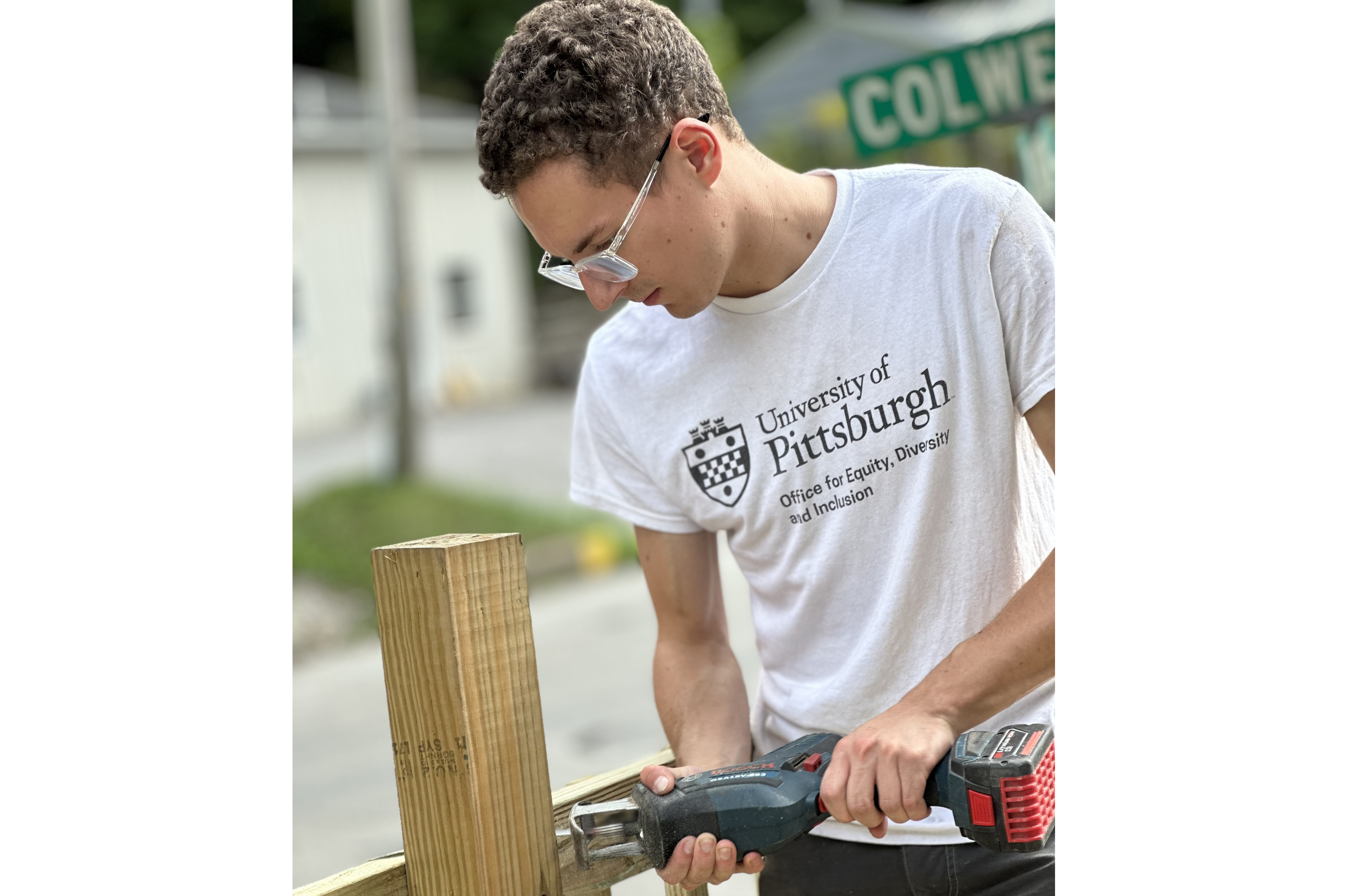 Volunteer using a sawzall on a workday.