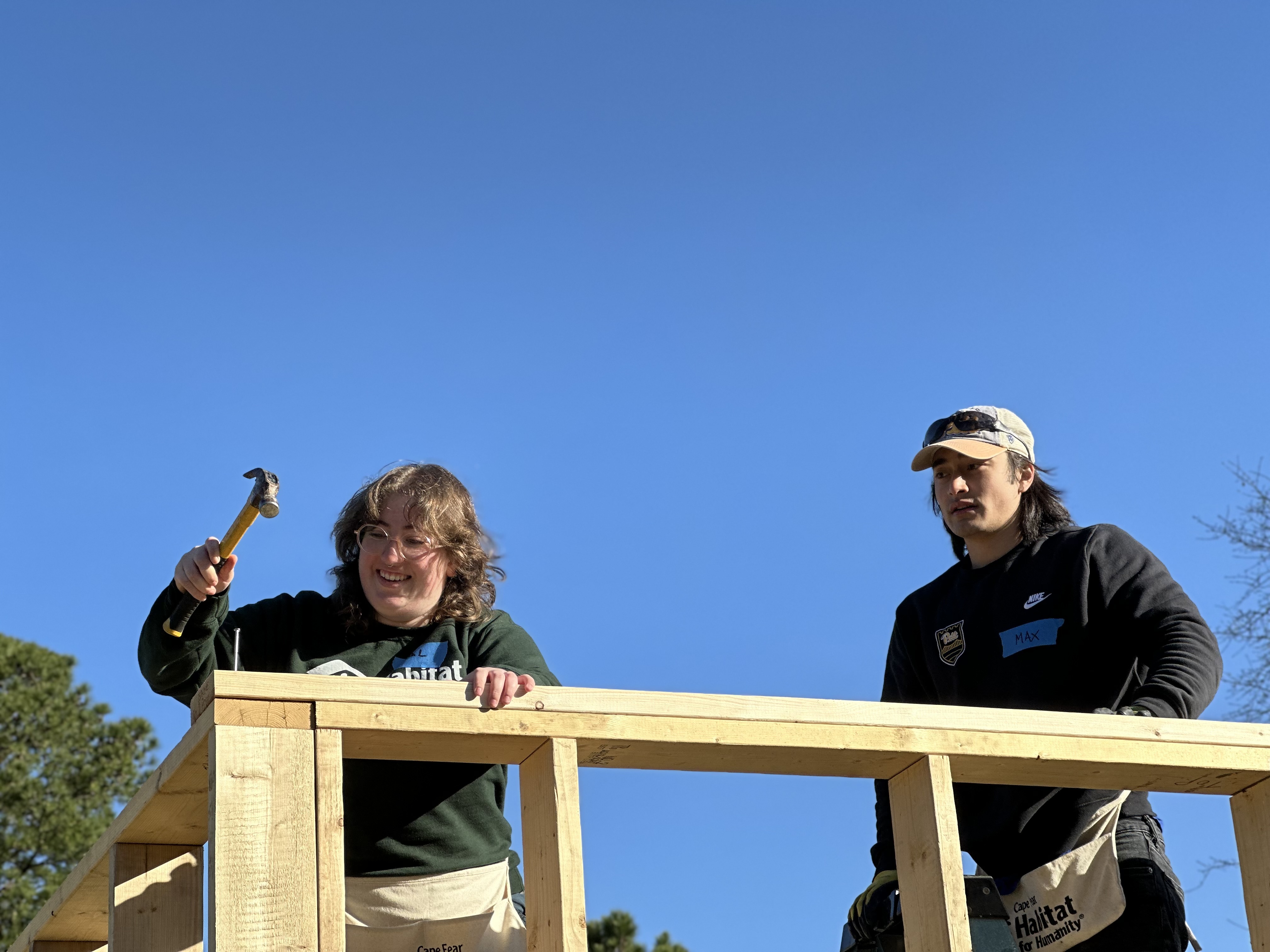Volunteers installing the top plate of a wall at a house in Cape Fear, NC.