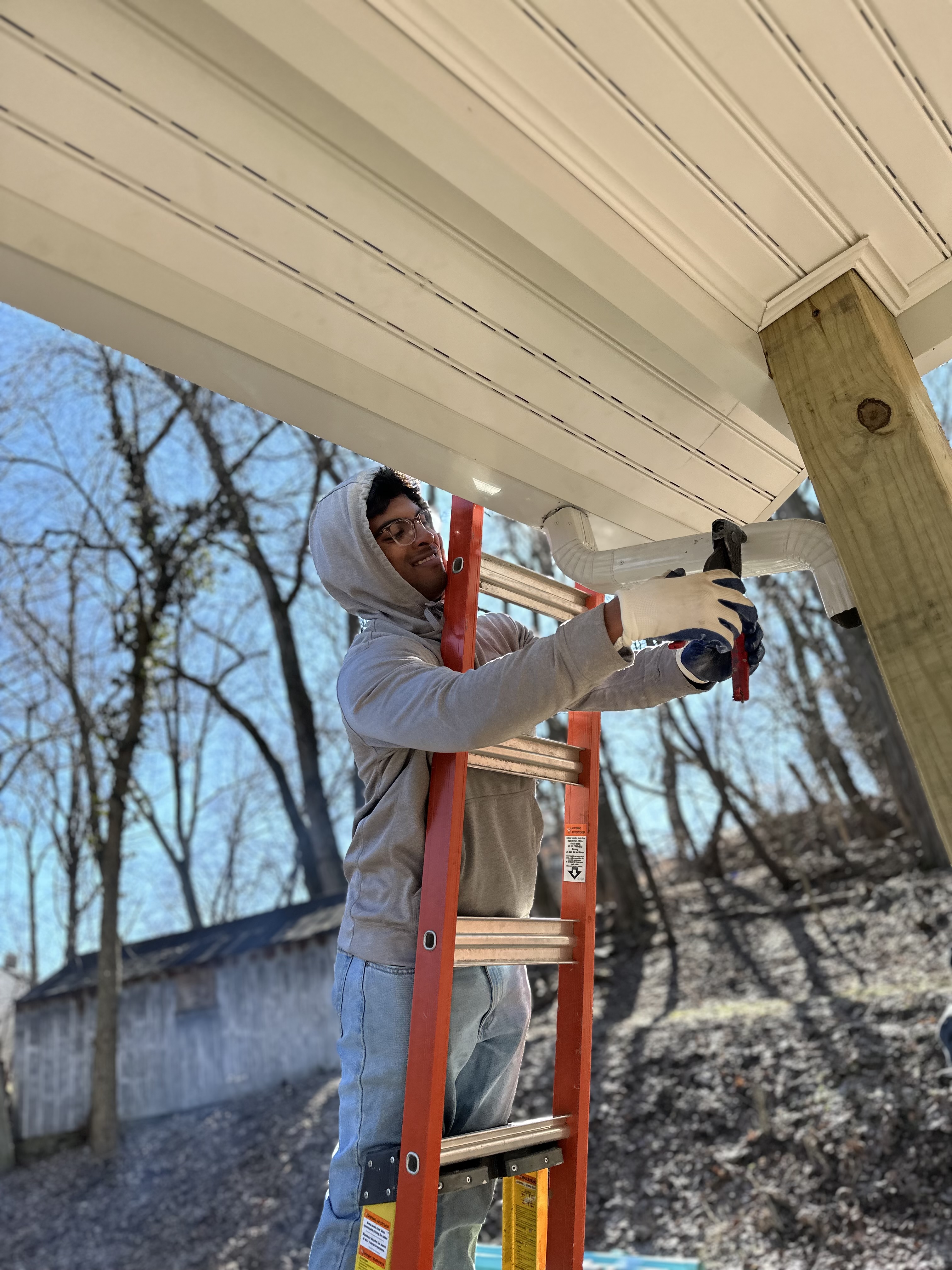 Volunteer working on gutters at our Open Hand Ministries workday.